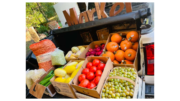 A stand full of vegetables and fruits