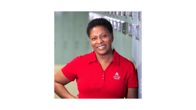 Deborah Pendergrass in red polo shirt smiling for camera