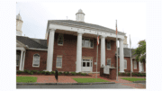 Brick Kennesaw government building with four tall wooden columns