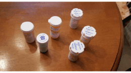six prescription pill bottles