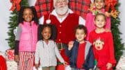 Santa surrounded by children
