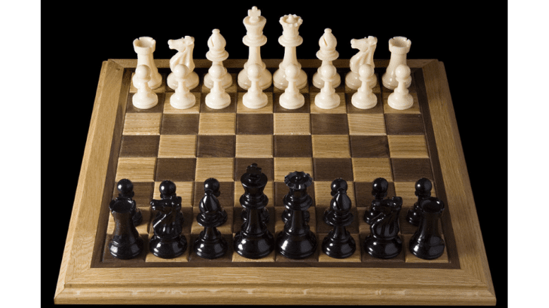 a chess board set up in opening position