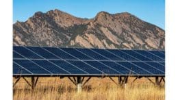 a photovoltaic array in front of mountains