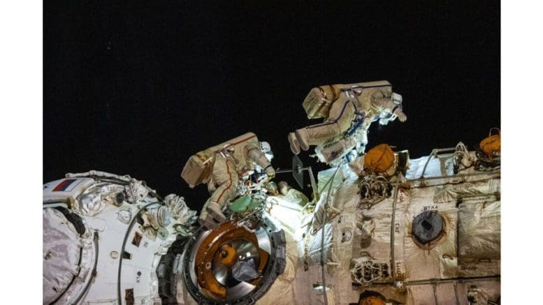 Cosmonauts Anton Shkaplerov (left) and Pyotr Dubrov (right) work to outfit the Nauka multipurpose laboratory module during a seven-hour and 11-minute spacewalk.