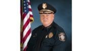 headshot of Marietta Police Chief Dan Flynn wearing uniform photographed next to an American flag