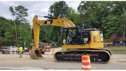 A front end loader scraping pavement