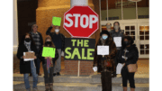 4 men and women outside Smyrna City Hall beside a large sign that says "Stop the Sale"