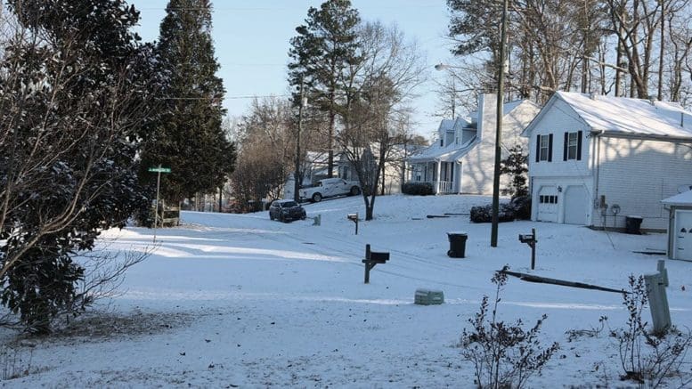 image of snow with house in background