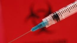 a syringe with the metal needle exposed