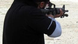 man firing AR 15