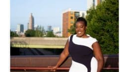 Melody Bray against backdrop of sky and buildings