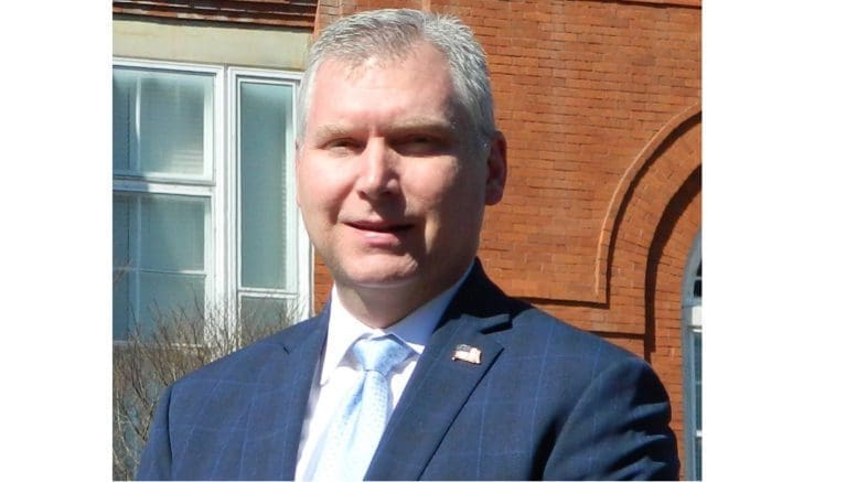 Eric Cunningham in front of red brick building