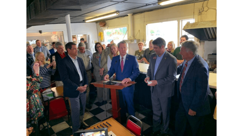 Brian Kemp shaking hands in a diner