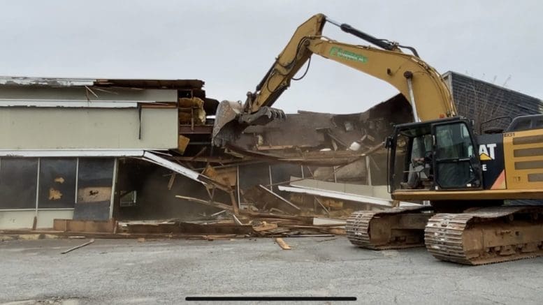 Front-end loader smashing building