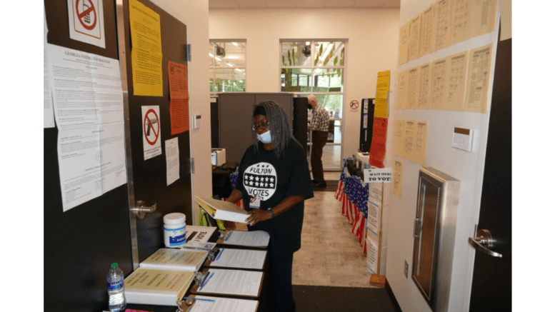 a woman working the polls at the Ponce Library