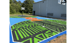 The new basketball court at the James T. Anderson Boys & Girls Club with a green abstract design