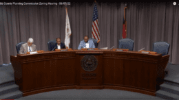 Three commissioners: Fred Beloin, David Anderson, and Stephen Vault at the podium