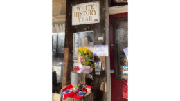 Storefront with the late Dent Myer and a White History Month sign and Confederate battle flag