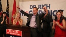 Rich McCormick in victory stance on podium