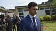 Jon Ossoff in suit walking away from group of people
