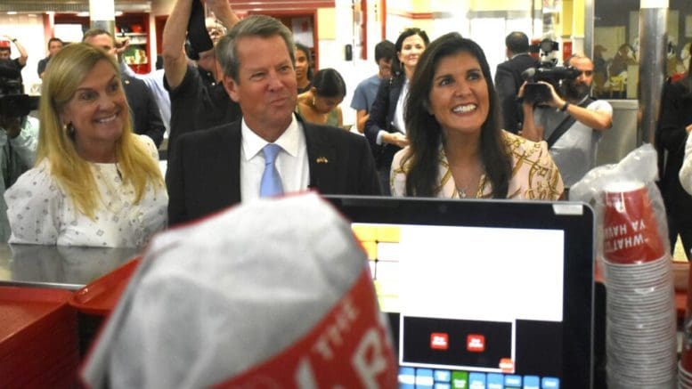 From left, First Lady Marty Kemp, Gov. Brian Kemp, and former U.N. Ambassador Nikki Haley make their order at Atlanta’s Varsity during a campaign stop. Ross Williams/Georgia Recorder