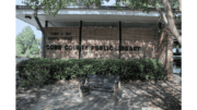 The brick front of the Lewis Ray Library, with dappled shade