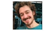 Zachary Bernknopf smiling, with stadium seats behind him