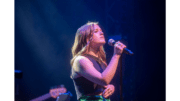 young woman with microphone singing
