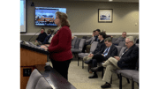 Janine Eveler at podium facing Kennesaw City Council with residents in chairs behind her