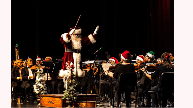 Man in Santa costume conducts orchestra