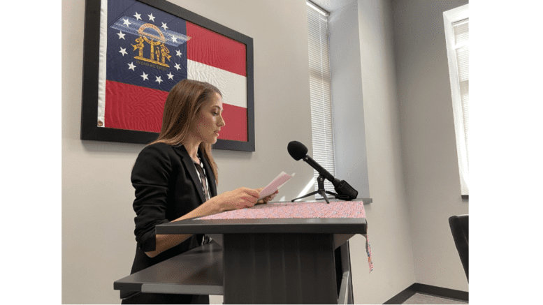 Madelyn Orochena speaks at Cobb Elections headquarters (photo by Rebecca Gaunt)