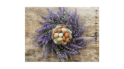 A bunch of colorful eggs surrounded by a spiral swirl of lavender stems and flowers