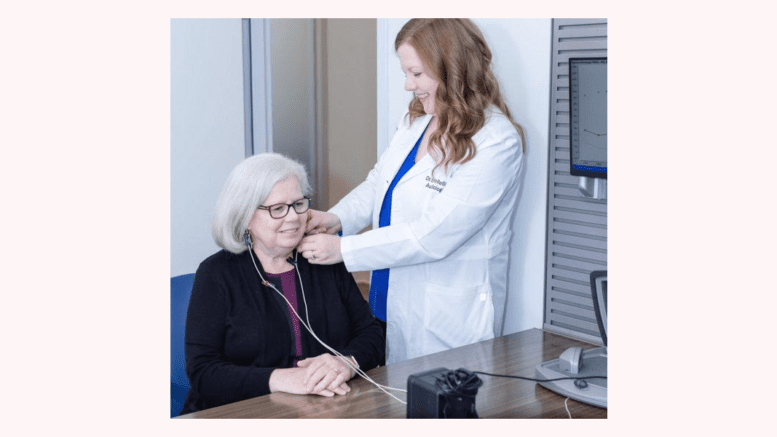 Doctor Rellinger administers a hearing test to a female patient