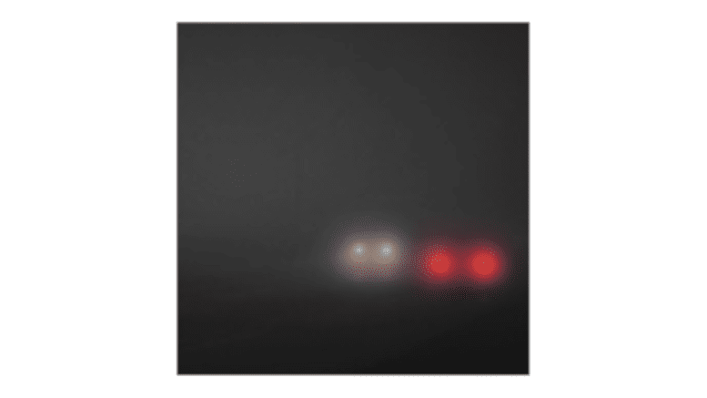 Headlights approaching through fog
