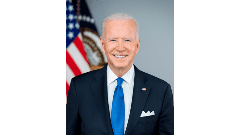 The official photo of President Joe Biden, in suit with tie in front of U.S. flag
