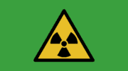 A radioactivity warning triangle with three internal triangles arranged around a dot with their points inward toward the center