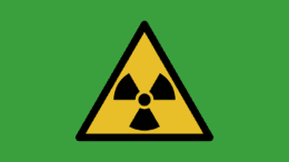 A radioactivity warning triangle with three internal triangles arranged around a dot with their points inward toward the center