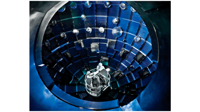 The target chamber at the National Ignition Facility has been the site of a number of breakthroughs in fusion physics. U.S. Department of Energy/Lawrence Livermore National Laboratory It's a spherical looking chamber with several scientists gathered around equipment in the center.