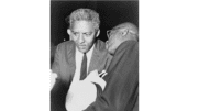 Bayard Rustin with another man leaning toward him talking