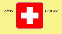 An inverted red cross with the words "safety" and "first aid" flanking it
