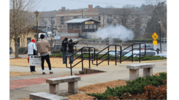 Two Black men dressed as Union Civil War soldiers fire muskets