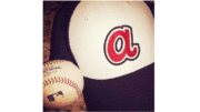 A baseball and an Atlanta Braves cap