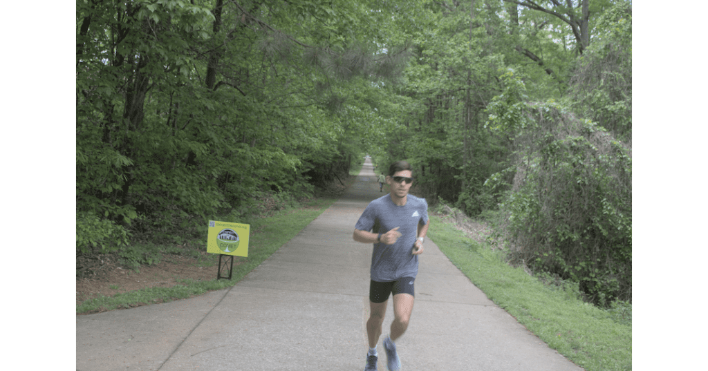 A runner on the Silver Comet Trail, male, wearing T-shirt and shorts