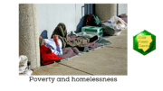 A homeless man lies down against a wall among his surroundings