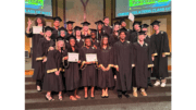 Students in graduation attire in group photo at the Sprayberry Interfaith Baccalaureate