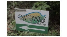 A sign with a Riverwalk Atlanta logo