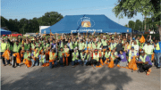 A large group of volunteers at the cleanup pose for a photo op.