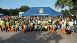 A large group of volunteers at the cleanup pose for a photo op.