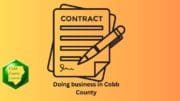 A graphic of a contract being signed with the words "Doing business in Cobb County" and a Cobb County Courier logo