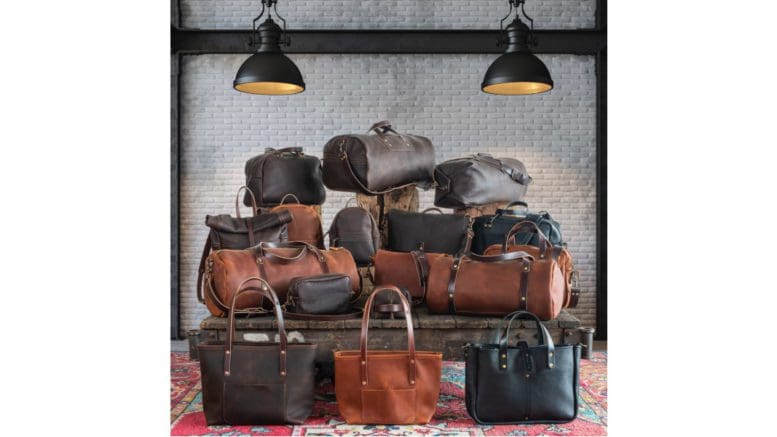 A large stack of leather bags of various types: purses, luggage etc